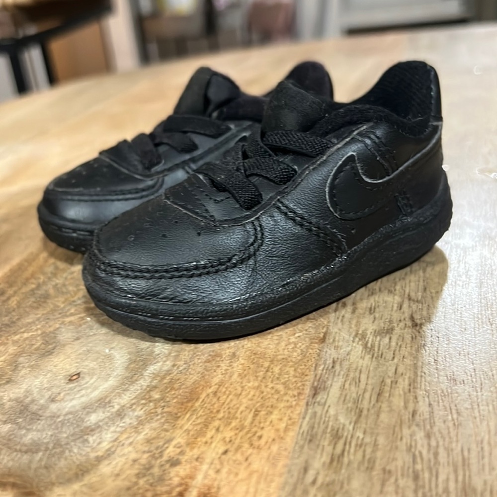 Kids black Nike shoes